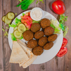Falafel Platter with Pita Bread, Pickles, Vegetables, and Tahini Sauce