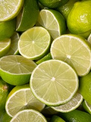 Lime citrus fruit cut in half wheel green background