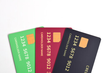 Three credit cards with chip on white background. Green, red, black credit cards