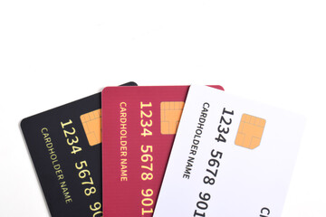 Three credit cards with chip on white background. White, red, black credit cards
