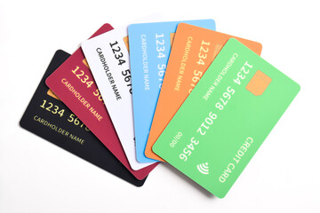 Stack of multicolored credit cards isolated on white background. Top view
