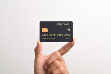 Hand holding black credit card isolated on white background.