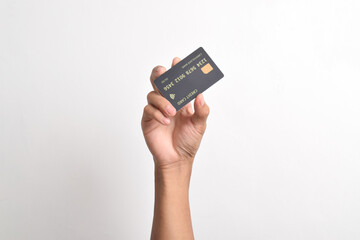 Close up of hand with black credit card isolated on white background. Shopping, finance and people concept