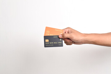 Hand is hold two credit cards. Black and orange credit cards isolated on white background.