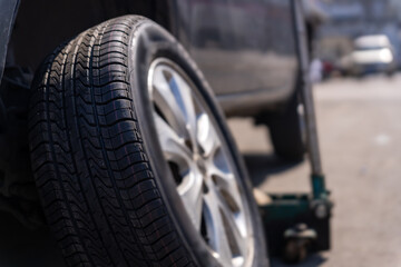 Close-Up of a Car Tire and Jack during a Wheel Replacement