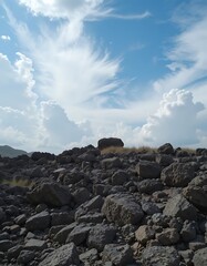 Dark Rocks Under a Cloudy Blue Sky