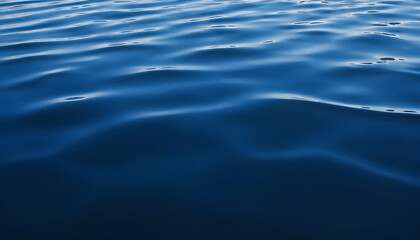 Obraz premium Dark blue abstract background. Reflection of light on a smooth surface of water with small waves.