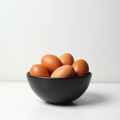 Brown eggs in a bowl isolated on white background
