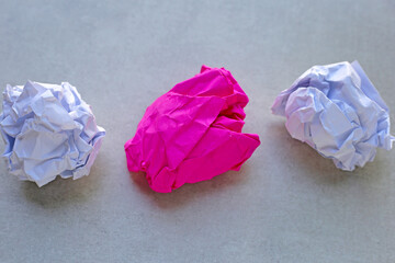 Clumped paper balls on grey background.