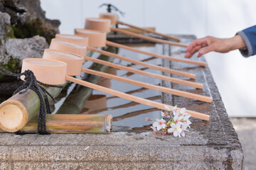 traditional ladles at the purification fountain chozuya in hokkekyo temple in ichikawa city