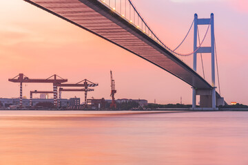 Fototapeta premium Jiangyin Yangtze River Bridge and the beautiful scenery of the Yangtze River and sunset in Jiangsu Province, China on August 20, 2024