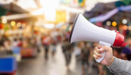 closeup of hand person holding megaphone with blurred background