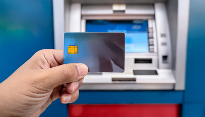 hand with card on atm machine background