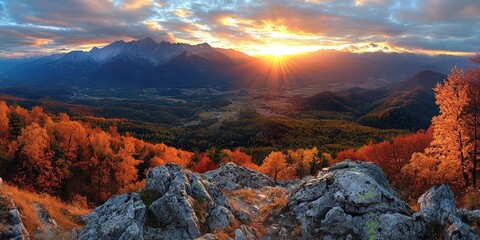 Naklejka premium Breathtaking Autumn Panorama of Mountains with Vibrant Fall Foliage and Dramatic Sky at Sunset