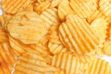 Close-up of Crispy Potato Chips with Wavy Texture, Golden Brown Color, and Light Seasoning on a White Background - Perfect for Snack, Food, and Junk Food Themes in High-Quality Stock Photography