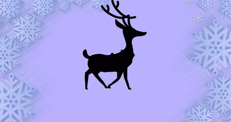 Black silhouette of reindeer walking over snowflakes forming a frame against purple background