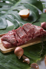 raw pork ribs on a wooden plate