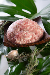 fresh raw minced pork on a wooden plate