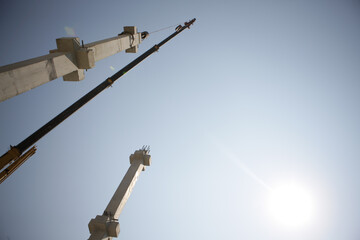Concrete Structure Under Construction with Scaffolding and Sunlight