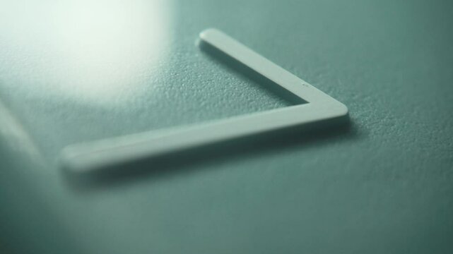 Number 7 on a blue wall clock with moving second hand. The time is seven o'clock