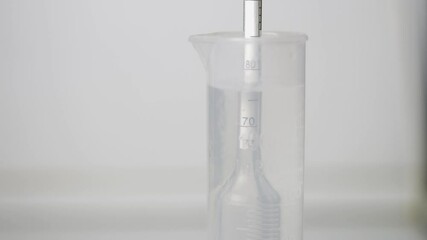 Distillation of braga into moonshine. Measurement of alcohol content.