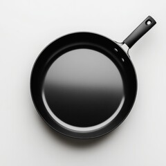 A sleek black frying pan is showcased on a pristine white surface, perfect for cooking