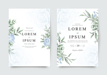 Elegant template wedding invitation cards are arranged with blue roses with green leaves