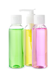 Various bottles with colored liquids and pumps arranged on white background