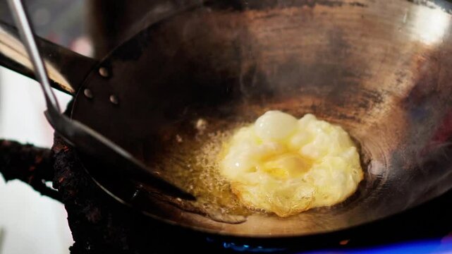 Video footage shows a chef frying eggs for lunch in a home kitchen.