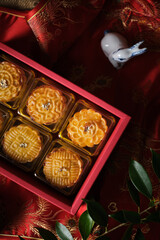 Box of Mooncake a Chinese traditional pastry for Mid-Autumn festival. set on rustic wooden table.