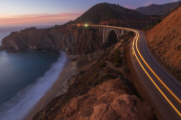 Car driving highway across Bixby Bridge