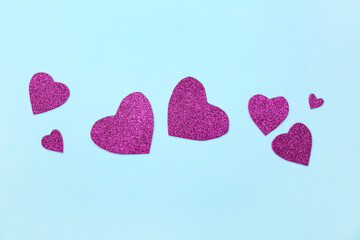 Many purple hearts on blue background. Valentine's Day celebration