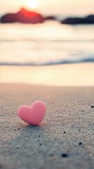 Fototapeta premium Pink heart on beach at sunset