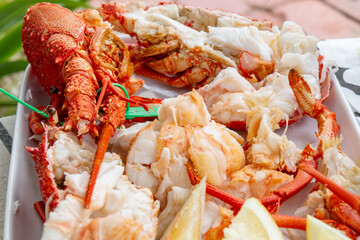 boiled lobster served with lemon wedges