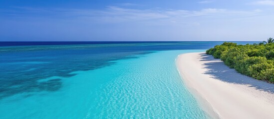 Obraz premium Serene tropical beach with azure waters and clear skies featuring pristine coastline and ample empty space for text or branding