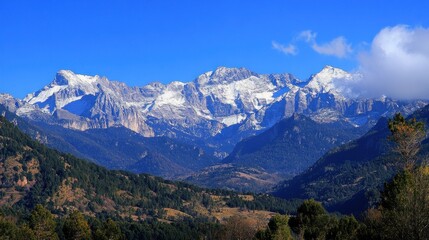 Majestic snow-capped mountain range under a clear blue sky.