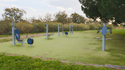 outdoor fitness park with modern exercise stations and shaded areas for workout fitness sessions