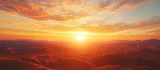 Fototapeta premium Stunning sunset view over colorful earth landscape with expansive sky and ample copy space for text or branding purposes