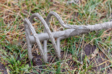 A rusty, old metal object is laying on the ground