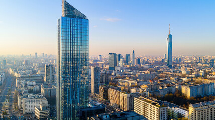 Fototapeta premium A sleek modern skyscraper featuring a reflective glass facade, surrounded by other high-rise buildings in a bustling city, showcasing urban architecture and vibrancy.