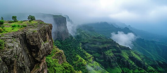 Majestic mountain landscape with lush greenery and mist in the Ghat region showcasing the beauty of nature and serene environment.
