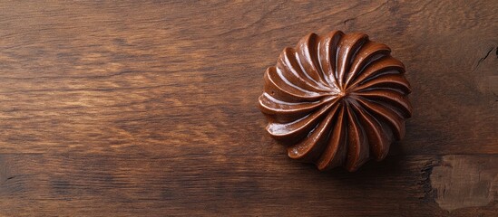 Decadent chocolate cupcake with intricate swirl design on rustic wooden background top view delicious dessert for culinary delights