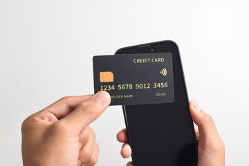 Male hands holding mobile phone and credit card isolated on white background