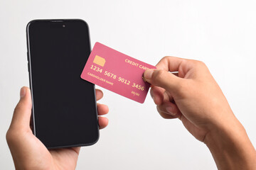 Male hands holding mobile phone and credit card isolated on white background