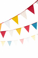 Fototapeta premium Bright multi-colored triangular flags on a white background. Holiday decor.