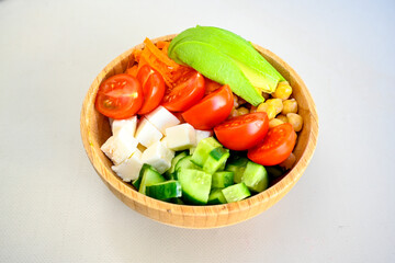 Green salad with arugula, lamb and tomatoes. Healthy vegan dish. Top view at table. Turkish Coban (choban) salata or Shepherds salad, Akdeniz salad in white bowl.