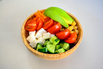 Green salad with arugula, lamb and tomatoes. Healthy vegan dish. Top view at table. Turkish Coban (choban) salata or Shepherds salad, Akdeniz salad in white bowl.