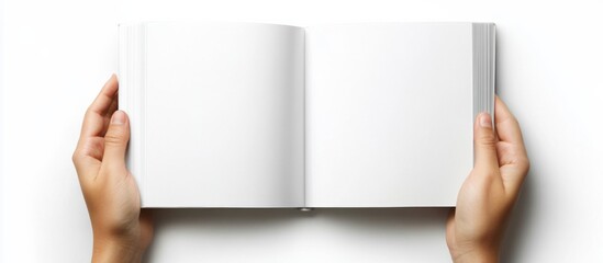 Top view of hands holding a blank book A5 open mockup
