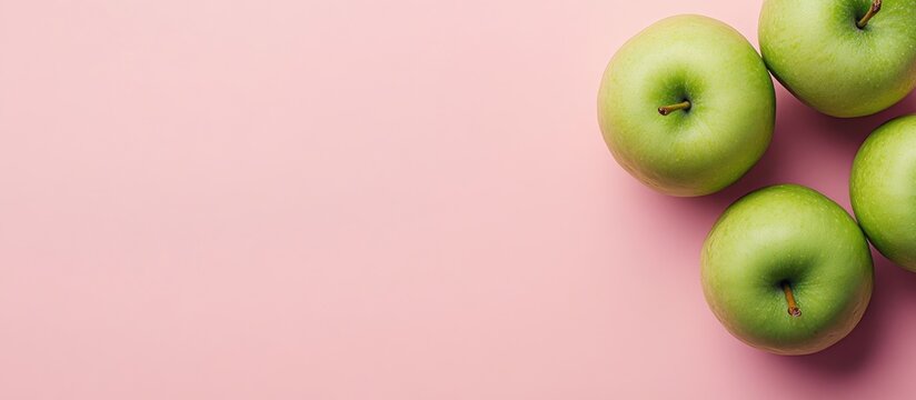 Green Apples with Measuring Tape on Soft Pink Background Healthy Lifestyle Concept with Space for Text or Nutrition Ideas