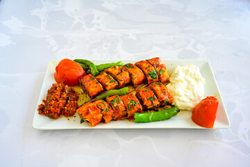 Famous Urfa meat liver, ciger wrapped by lavash with roasted chili pepper, onion and sauce in...